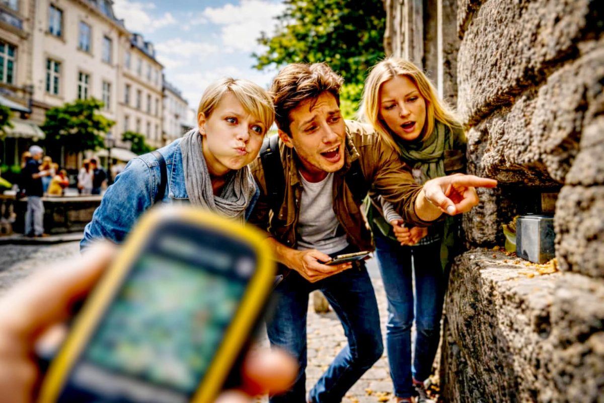Teilnehmende eines Krimi-Geocaching-Teamevents sind draußen mit GPS-Geräten unterwegs.